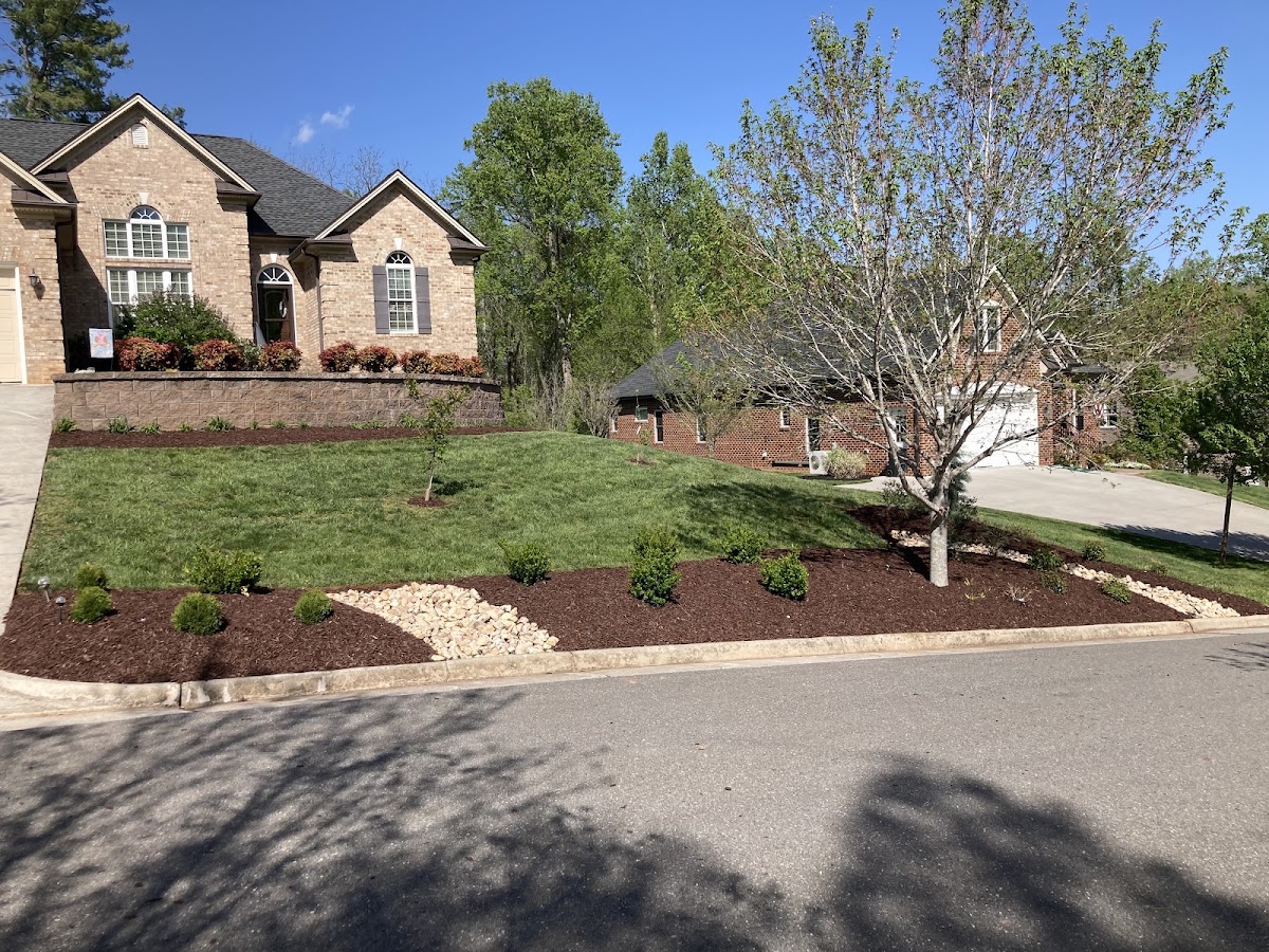 New front bed with shrubs and a river rock border